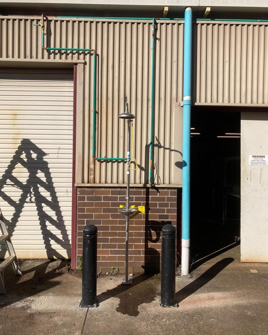 Outdoor shower and eyewash station installed at a commercial site